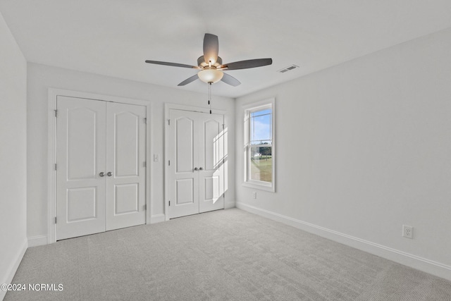 unfurnished bedroom with ceiling fan and light carpet