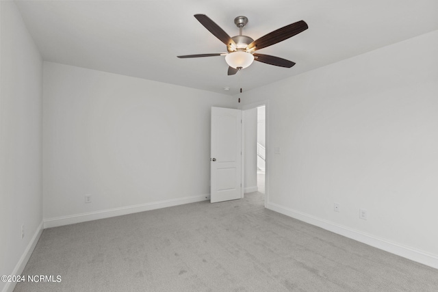 empty room featuring light colored carpet and ceiling fan