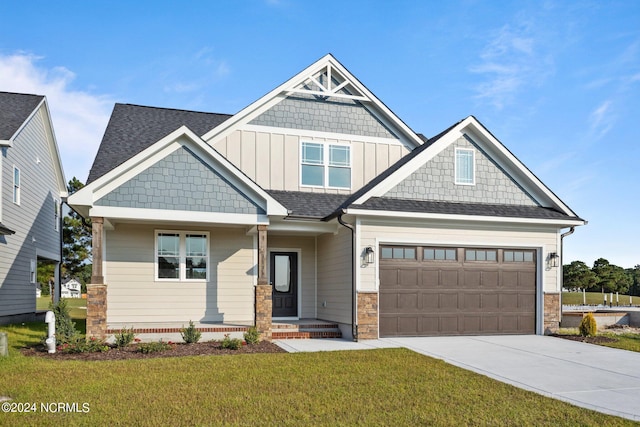 craftsman-style home with a garage and a front lawn