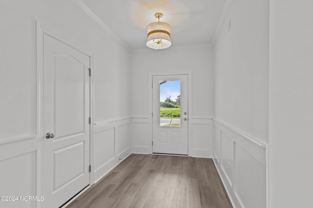 doorway to outside featuring light hardwood / wood-style flooring and ornamental molding