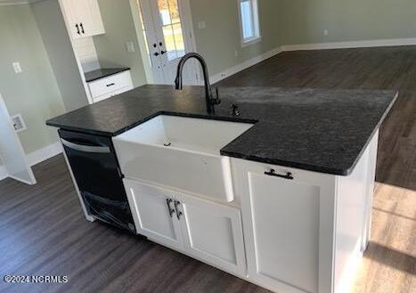 kitchen with a kitchen island, sink, dark hardwood / wood-style floors, and white cabinets