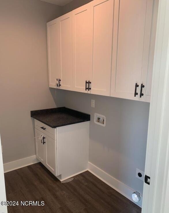 laundry area featuring washer hookup, cabinet space, dark wood finished floors, and baseboards