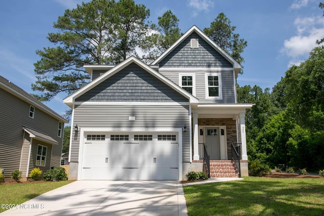 craftsman-style house with a garage, driveway, and a front lawn