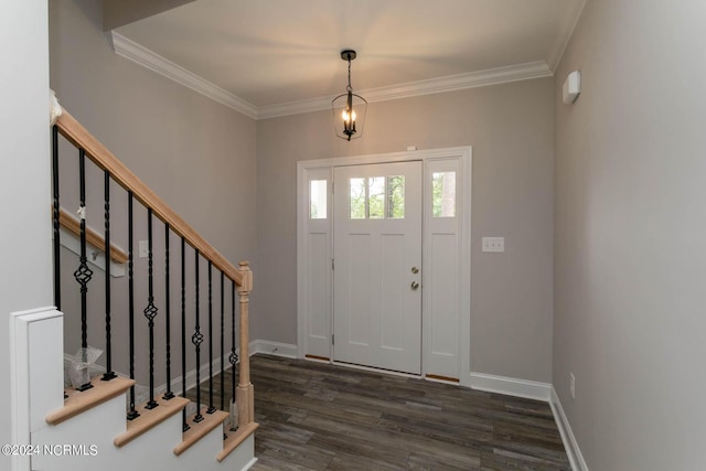 foyer entrance featuring crown molding, dark wood finished floors, stairway, and baseboards