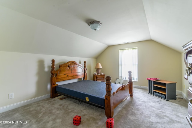 bedroom featuring lofted ceiling, carpet, and baseboards