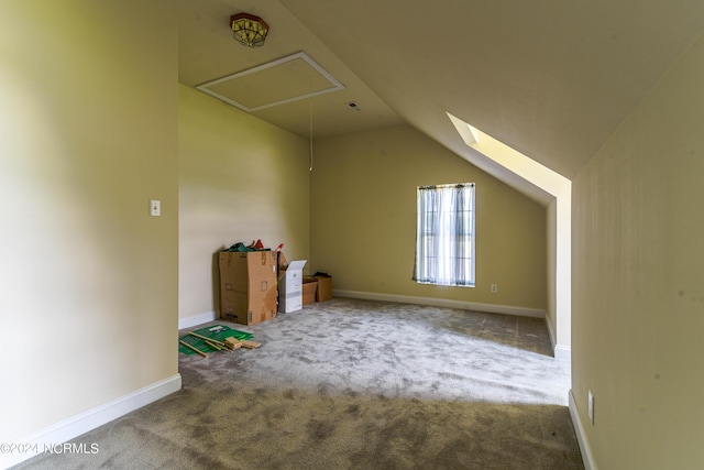 additional living space with attic access, carpet, vaulted ceiling, and baseboards