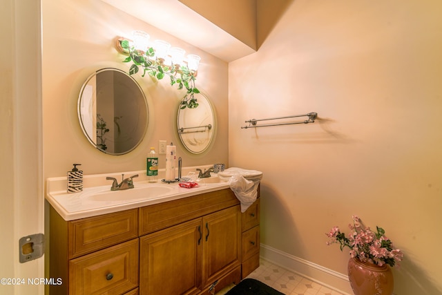 bathroom featuring tile patterned floors, baseboards, and vanity