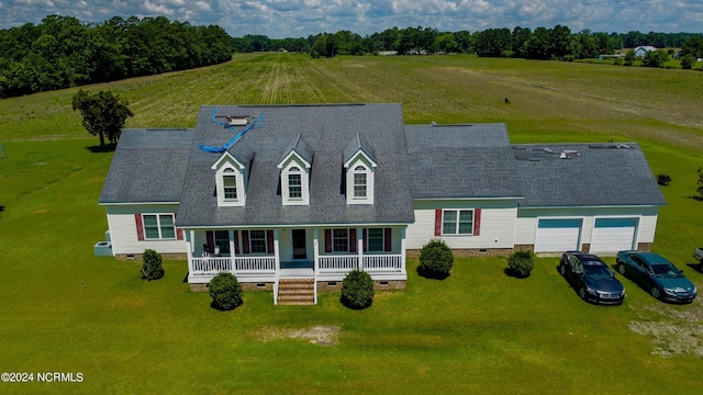 view of front of property featuring covered porch, driveway, a front lawn, and crawl space