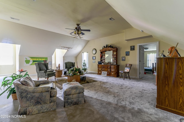 carpeted living area featuring a wealth of natural light, lofted ceiling, and a ceiling fan