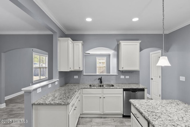 kitchen featuring sink, white cabinetry, hanging light fixtures, tasteful backsplash, and stainless steel dishwasher