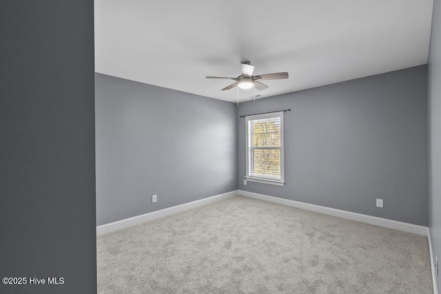 unfurnished room with ceiling fan and light carpet