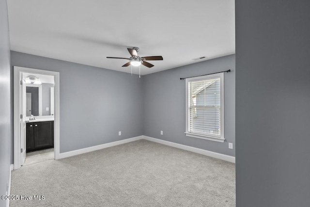 carpeted spare room with sink and ceiling fan