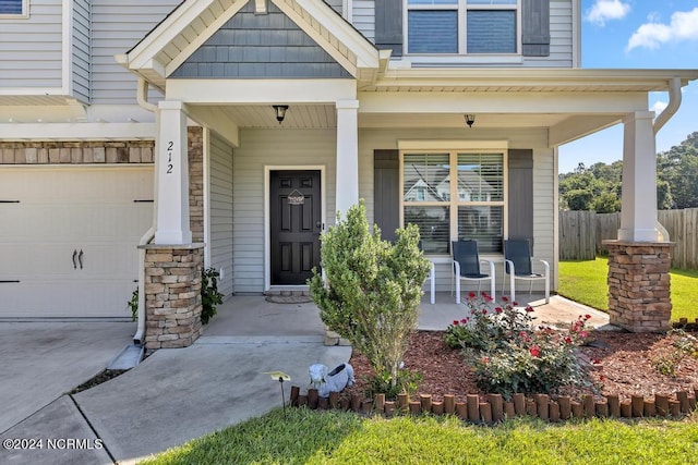 property entrance with a porch and a garage