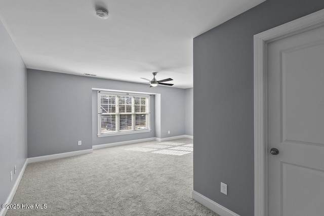 unfurnished room featuring ceiling fan and carpet floors