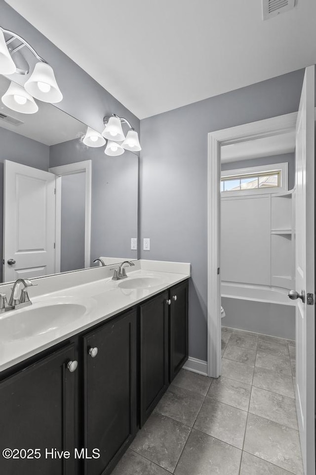 full bathroom featuring vanity, tile patterned floors, toilet, and washtub / shower combination