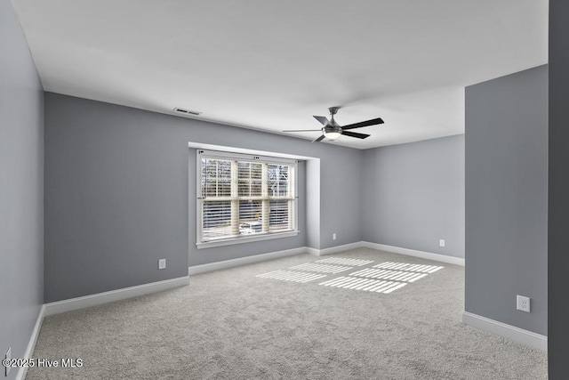 carpeted spare room featuring ceiling fan