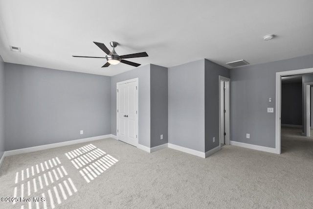 unfurnished bedroom featuring light carpet and ceiling fan