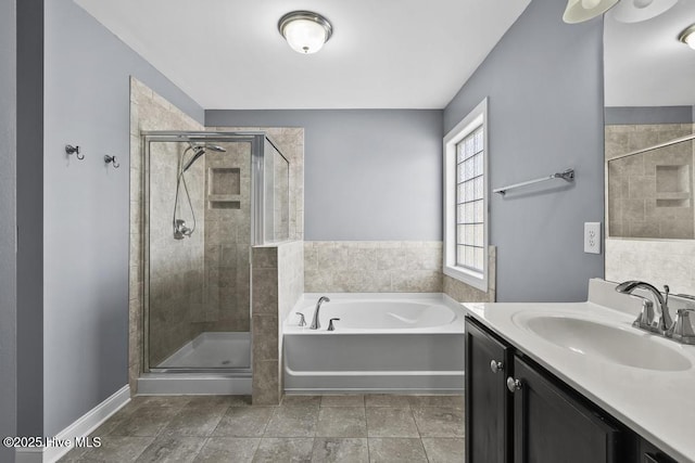 bathroom with vanity and separate shower and tub