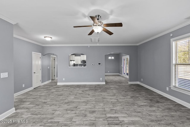 unfurnished living room with crown molding, ceiling fan with notable chandelier, and light wood-type flooring