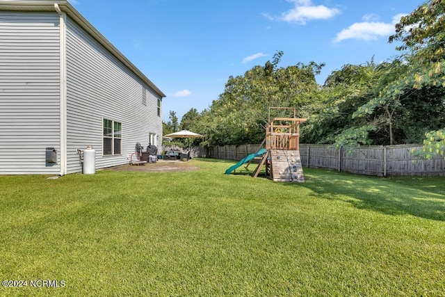 view of yard featuring a playground and a patio