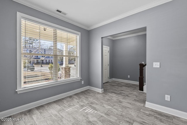 unfurnished room with ornamental molding and light wood-type flooring