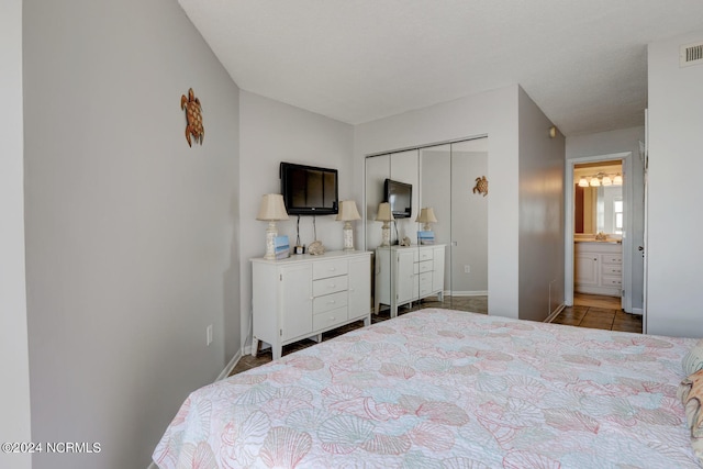 bedroom featuring ensuite bathroom and a closet