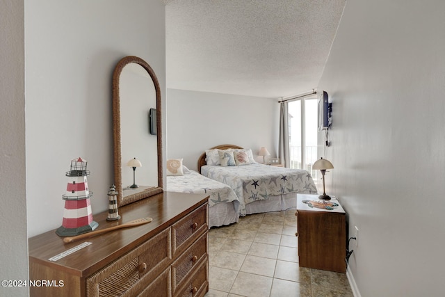 tiled bedroom with a textured ceiling