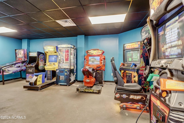 playroom featuring concrete floors and a drop ceiling