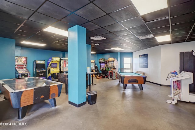 playroom with a paneled ceiling, pool table, and concrete floors