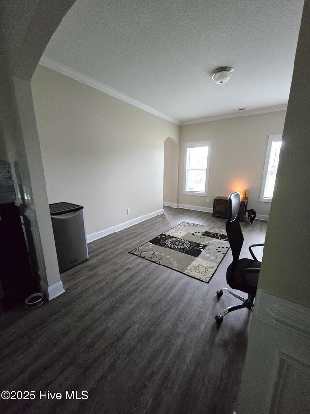 206 Messenger Ct, Jacksonville, NC 28546 - office space featuring arched walkways, crown molding, dark wood-style flooring, baseboards, and a textured ceiling