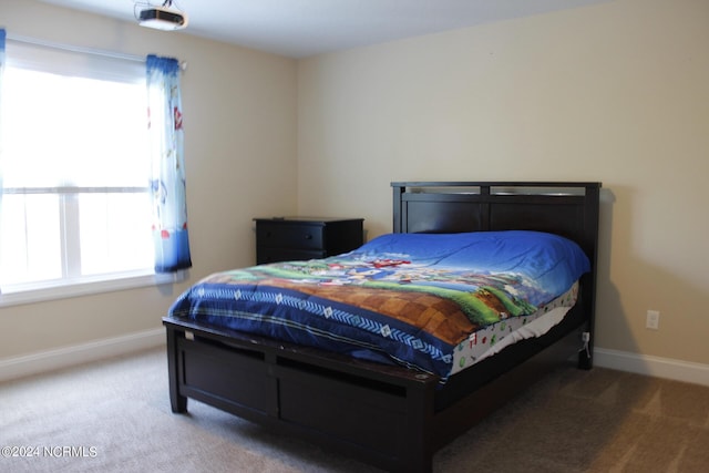 carpeted bedroom featuring baseboards