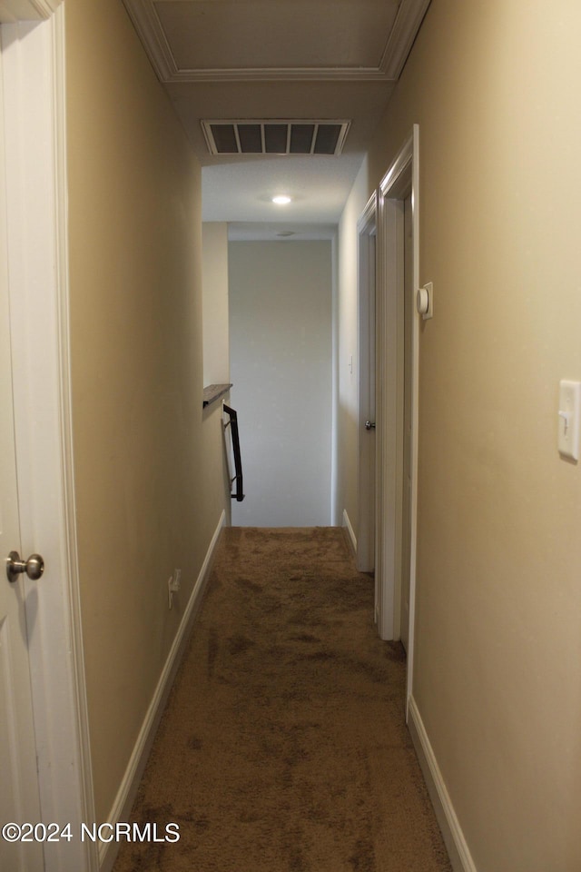 corridor featuring an upstairs landing, carpet flooring, visible vents, and baseboards
