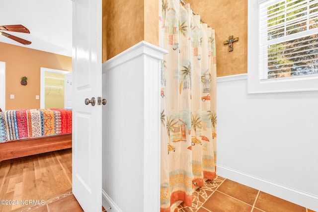 bathroom with tile patterned floors and ceiling fan