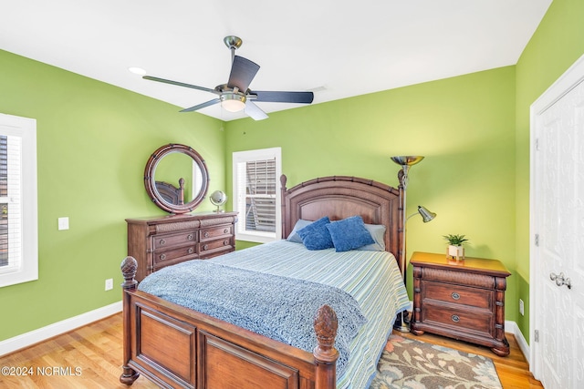 bedroom with light hardwood / wood-style flooring and ceiling fan