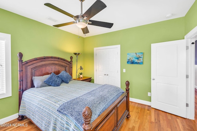 bedroom with ceiling fan, a closet, and light hardwood / wood-style floors