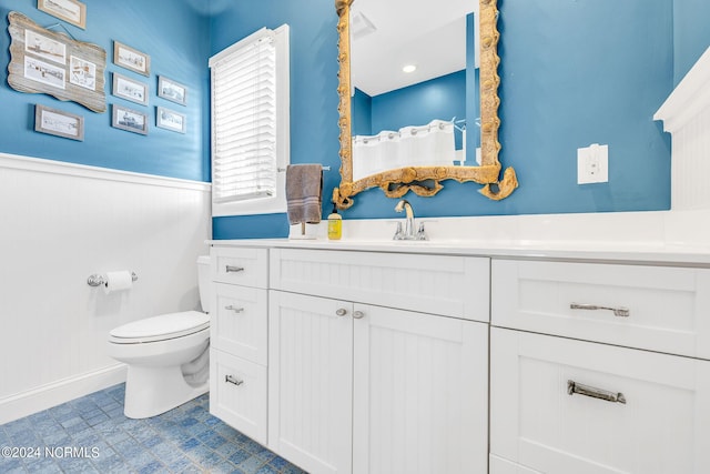 bathroom featuring vanity and toilet