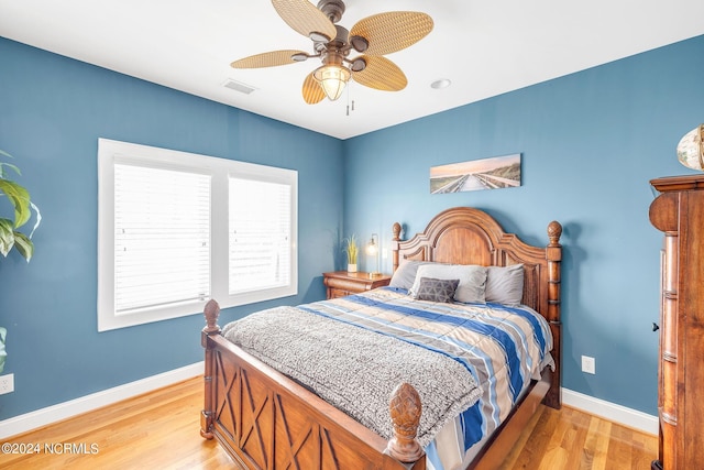 bedroom with ceiling fan and light hardwood / wood-style floors