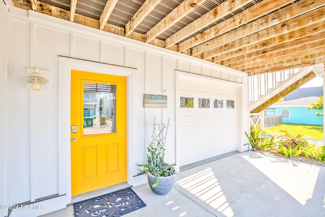 doorway to property with a garage