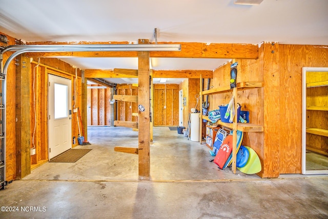 miscellaneous room with wood walls and concrete flooring