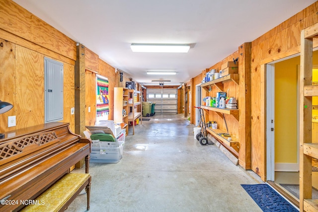 miscellaneous room featuring electric panel and wooden walls