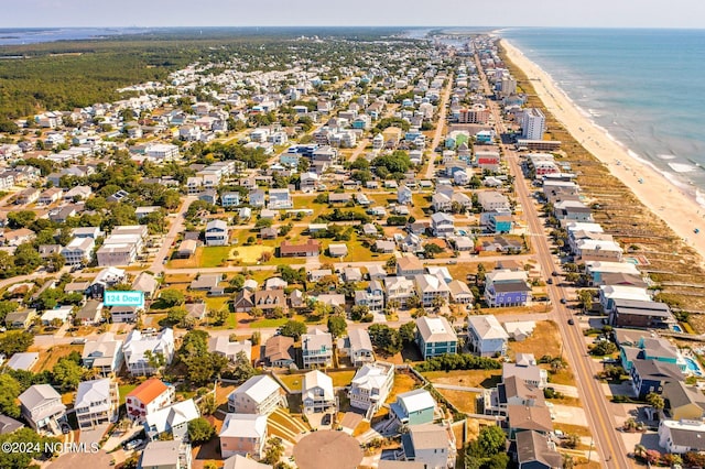 birds eye view of property featuring a beach view and a water view