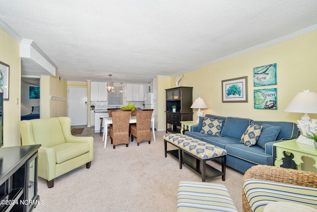 carpeted living room featuring ornamental molding, a chandelier, and a textured ceiling