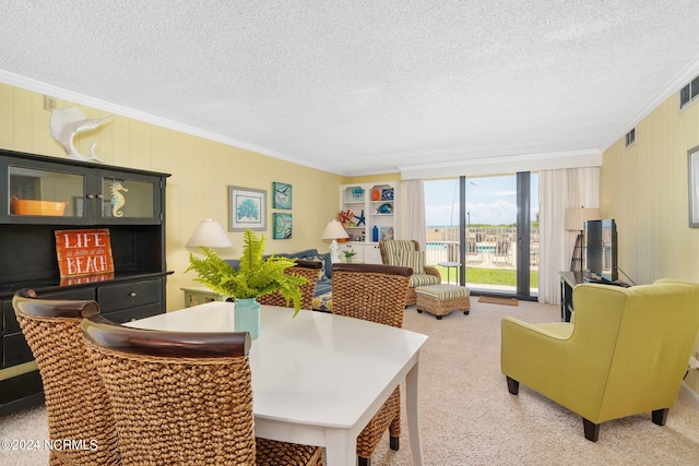 dining space featuring ornamental molding, carpet, and a textured ceiling