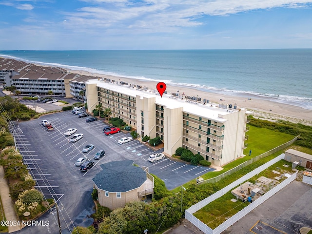 drone / aerial view with a water view and a beach view