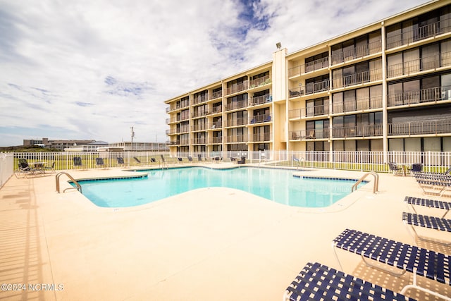 view of swimming pool with a patio area