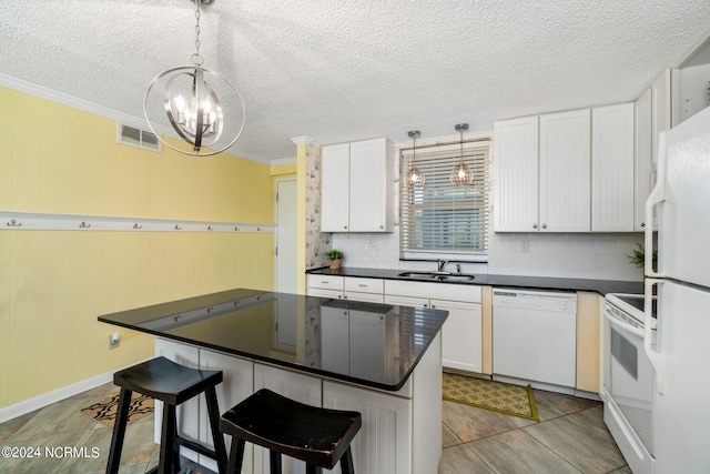 kitchen with sink, white appliances, white cabinetry, a kitchen breakfast bar, and decorative light fixtures