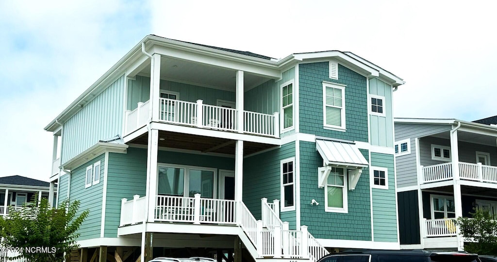 rear view of house featuring board and batten siding