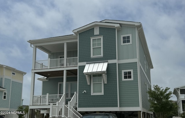 view of front of property with a balcony, stairway, a porch, and board and batten siding