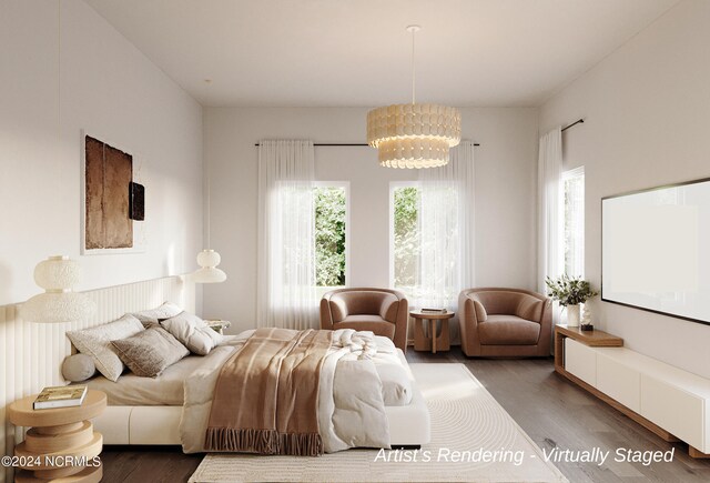 bedroom with a notable chandelier and hardwood / wood-style flooring