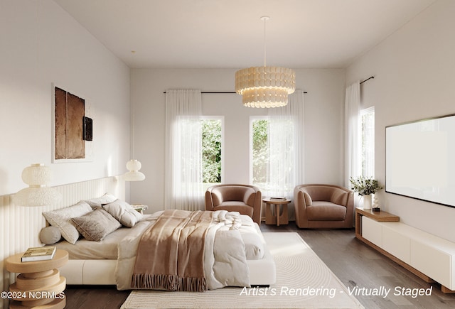 bedroom featuring multiple windows, wood finished floors, and a notable chandelier